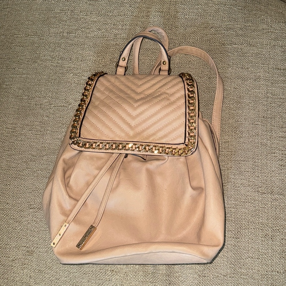 Cream backpack with gold tone accents